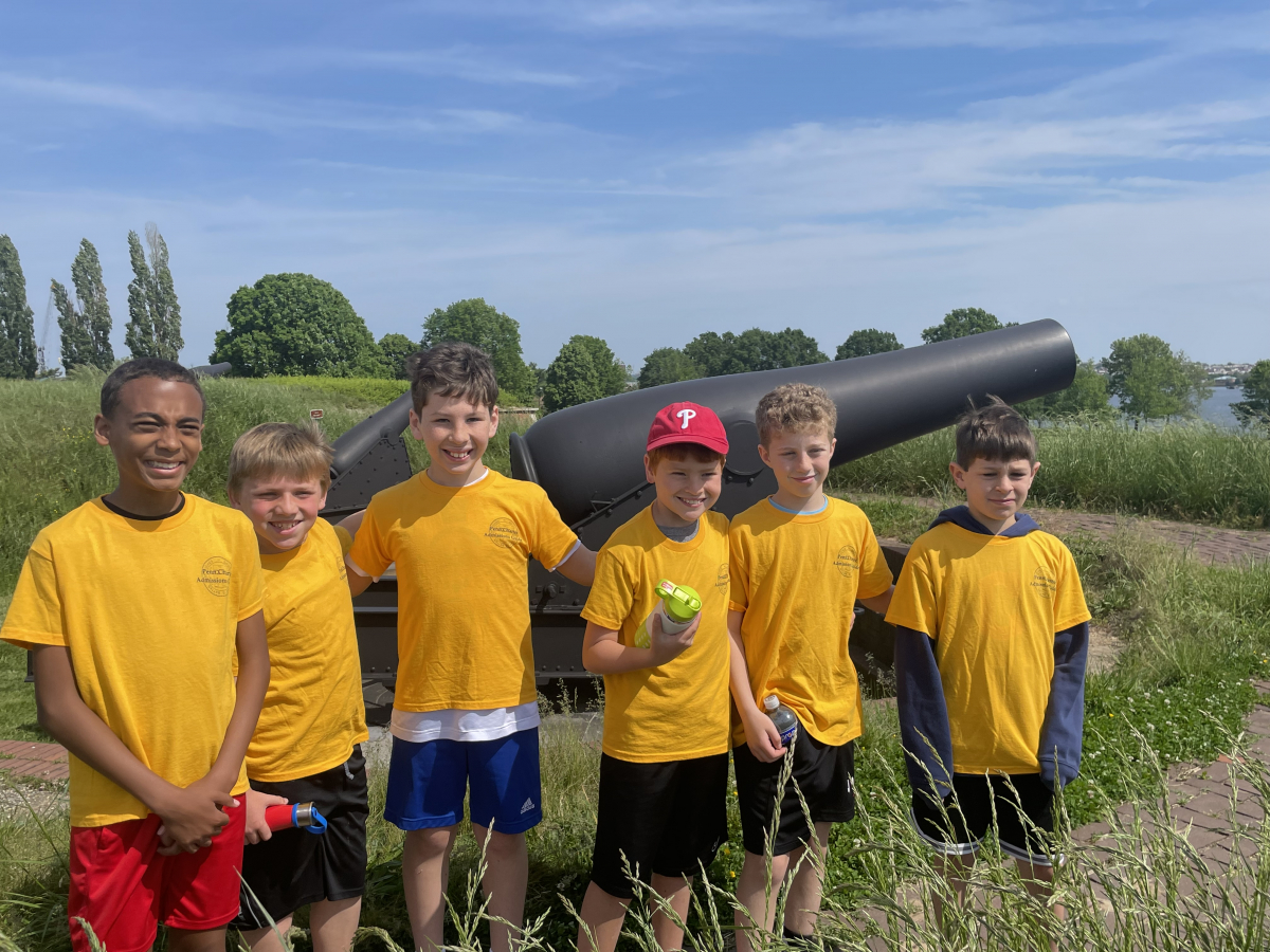 Classmates on a Field Trip in Front of a Fort McHenry Cannon